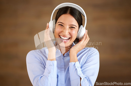 Image of Happy professional woman, headphones and listen to music in portrait, break at work with podcast and mockup space. Happiness, stress relief and audio streaming online, female worker and wireless tech