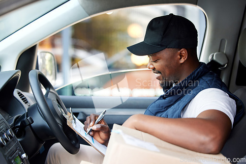 Image of Delivery man, transport and black man writing on a clipboard with a smile for shipping or courier service. Happy african person or driver with cardboard box or package and management list in a van