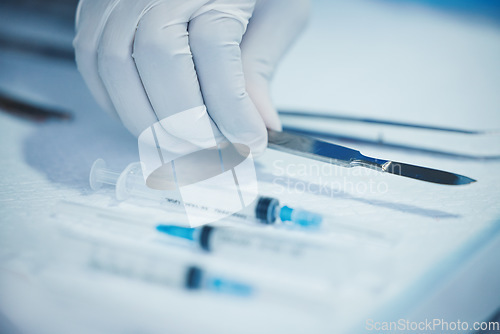 Image of Closeup of hand, doctor and medical tools, scalpel and needle syringe for surgical procedure in healthcare. Medicine, health insurance and operation, surgeon person in hospital with clean instruments