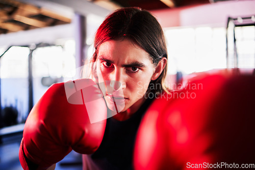 Image of Portrait, man and boxer in gym for workout, exercise or training for fight. Boxing sports, face and serious fitness athlete punch for mma challenge, competition or exercising for martial arts power.