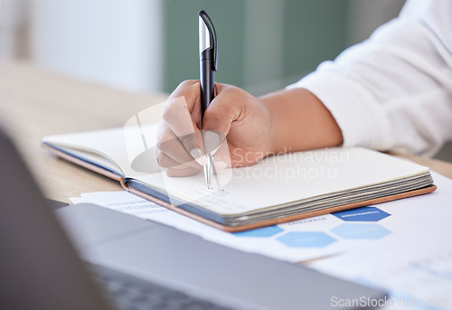 Image of Closeup, businesswoman writing in a notebook and at her desk in a modern office workplace. Planning or schedule, brainstorming idea or startup and female person write notes in a book for strategy