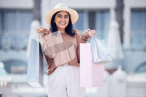 Image of Woman in portrait, shopping bag and retail at outdoor mall, smile with purchase, luxury and shop discount. Happy female customer, fashion designer brand and buyer choice with store promotion and sale