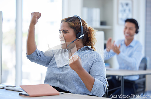 Image of Woman, call center and fist celebration for success at desk for telemarketing or sales target. Excited consultant person winning crm bonus, deal or award with a headset for customer service startup