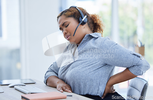 Image of Call center, back pain and woman consulting for customer service while suffering arthritis or inflammation in office. Spine, backache and female consultant with posture issue while working for crm