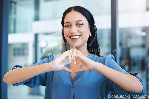 Image of Happy woman, call center and portrait with heart hands in customer service, support or telemarketing at office. Female person consultant agent with smile or loving emoji in online advice at workplace