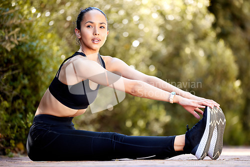 Image of Forward spine stretch, park and woman exercise for health, fitness and wellness. Sports, stretching legs and female athlete warm up body to get ready to start cardio workout, training and running.