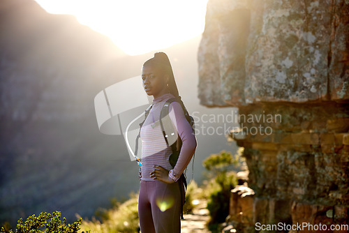 Image of Portrait, hiking and black woman in nature for exercise, adventure and travel at sunset. Hiker, fitness and female person trekking in South Africa, workout and serious training on mountain mockup.