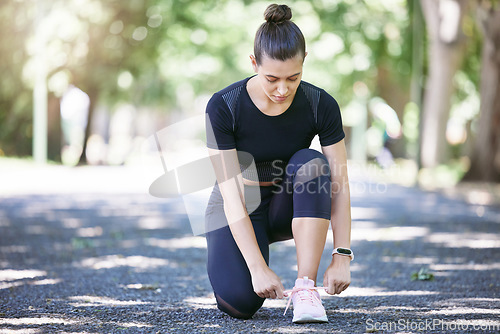 Image of Fitness, woman tying her shoelaces and running outdoors at a nature park. Workout or exercise, training or health wellness and female person prepare to run outside for motivation with shoes.