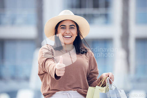 Image of Happy woman, shopping bag and thumbs up for winning, discount or sale in city outdoors. Portrait of excited female person or shopper with thumb emoji, yes sign or like for luxury sales in urban town