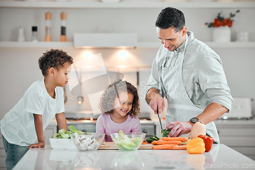 Image of Cooking, help and salad with family in kitchen for health, nutrition and food. Diet, support and dinner with man and children cutting vegetables at home for wellness, meal prep and learning