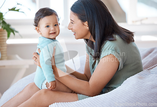 Image of Happy, mother and holding with baby on lap in home for love, care and quality time together for play, growth and development. Mom, infant and bond with newborn girl kid on bean bag in nursery room