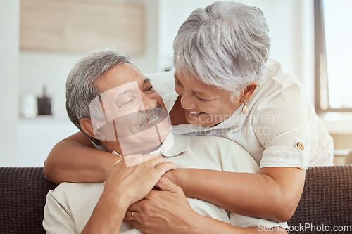 Image of Love, hug and elderly couple on a sofa, happy and relax, laughing and talking their home together. Embrace, smile and senior man with woman on couch in a living room, cheerful and enjoying retirement