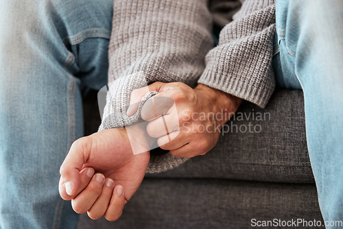 Image of Hands, anxiety and closeup of a man with depression, mental health problem and stress in home lounge. Male person on a couch for psychology, fear and life crisis on a sofa while sad or depressed