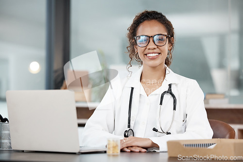 Image of Doctor, woman in portrait and happy, healthcare and medical professional in office with stethoscope and laptop. Female person in medicine, desk and health insurance with cardiologist at hospital