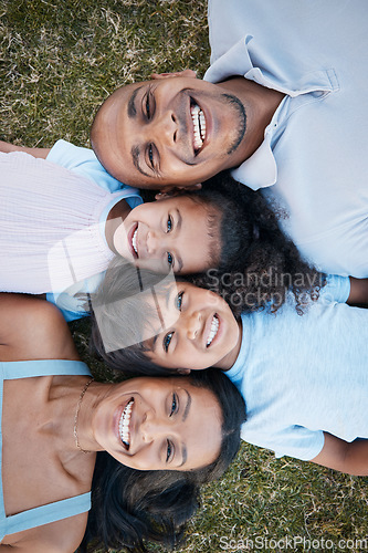 Image of Family, portrait and lying on grass in garden with mother, father and kids together with love. Face, top view and dad with mom and children with parent support and care on a lawn with happy smile
