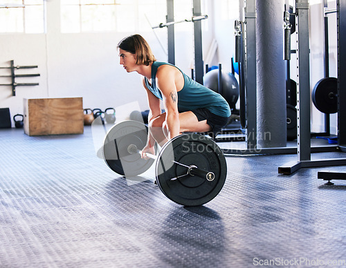 Image of Fitness, barbell and deadlift with a man at gym for a workout, exercise or training. Male athlete person with iron weight for strong muscle, focus and agile performance or commitment at wellness club