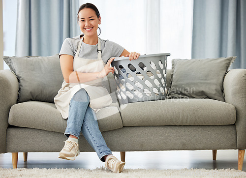 Image of Happy asian woman, laundry and sofa for housekeeping, cleaning or hygiene in living room at home. Portrait of female person, cleaner or domestic with smile for clean clothing or washing on couch