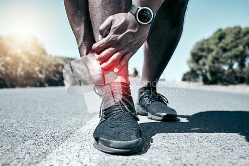 Image of Fitness, ankle and accident with a sports man holding his joint in pain while outdoor for a workout. Exercise, anatomy and injury with a male athlete feeling tender while training for recreation