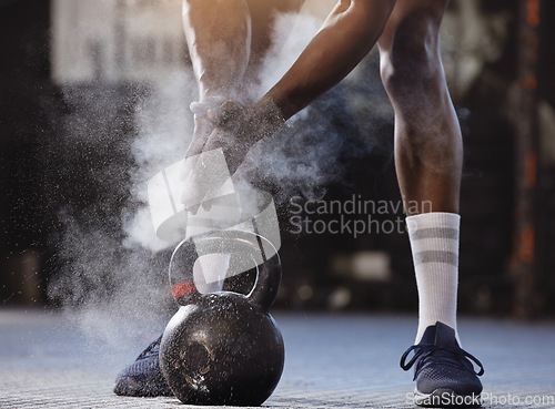 Image of Powder, hands and kettlebell exercise with a man at gym for fitness, training and strong muscle. Athlete or bodybuilder person start weights workout for power and performance with chalk at a club