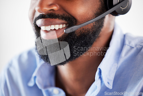 Image of Online communication, black man with headset and smile at his desk in a modern workplace office. Telemarketing or consultant, support or customer service and male call center agent at workstation