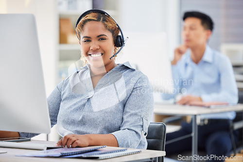 Image of Business woman, portrait and call center consultation in a office working on a computer. Smile, African female worker and web support of a contact us employee with professional telemarketing job