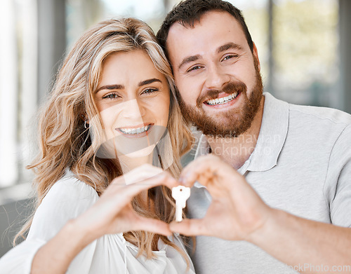 Image of New home, couple and hand heart with key for moving, love and mortgage celebration portrait. Happiness, emoji and excited hands sign with house and real estate keys together with property support