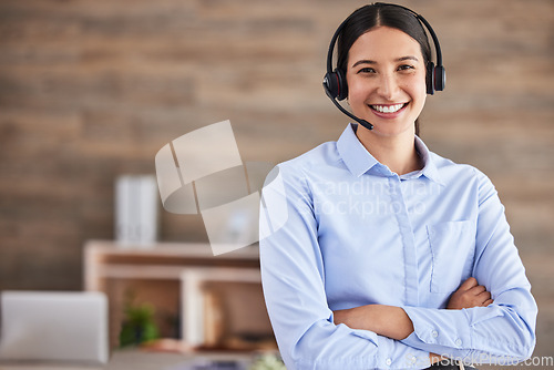 Image of Call center, portrait and woman with arms crossed and headset for calls, working in communication and crm office. Agent, smile and happy customer service worker to help, support and consulting advice