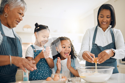 Image of Grandmother, mom or excited children baking in kitchen as a happy family with young girl learning a recipe. Cracking eggs, clapping or grandma smiling or teaching kids to bake a cake for development