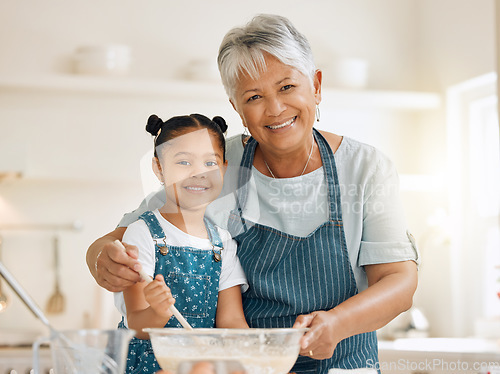 Image of Grandmother, portrait or child baking in kitchen as a happy family with young girl learning cookies recipe. Mixing cake flour, development or grandma smiling, helping or teaching kid to bake at home