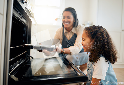 Image of Mother, oven or child baking in kitchen as a happy family with young girl learning cookies recipe. Mixing cake, daughter or mom smiling, helping or teaching kid to bake with tray for development