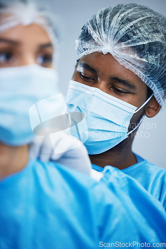 Image of Surgery, preparation and doctor team getting ready in hospital for medical, innovation and operation. Healthcare, experts and woman with man in theater for uniform, teamwork and medical collaboration