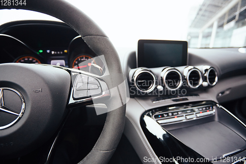 Image of Control buttons on steering wheel. Car interior.