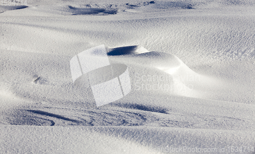 Image of Deep snowdrifts - a winter frosty morning. On the ground lay snowdrifts after a night of snow