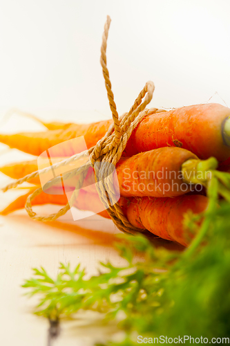 Image of baby carrots bunch tied with rope