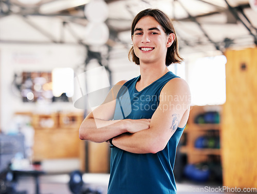 Image of Coach, portrait and man with arms crossed in gym ready to start training, workout or exercise for health and wellness. Fitness, face and smile of confident athlete or personal trainer from Canada.