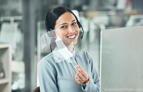 Image of Customer service, woman call center agent with face mask and headset at her computer in her modern office. Telemarketing or networking, online communication or crm and female person for support