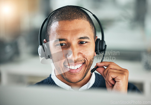 Image of Face, call center and a man with a headset at computer for customer service or sales. Smile of african person at a pc and talking on microphone as telemarketing, crm support or help desk consultant