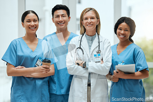 Image of Portrait, medical and a woman doctor arms crossed, standing with her team in the hospital for healthcare. Leadership, health and teamwork with a female medicine professional in a clinic for treatment