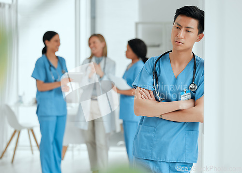 Image of Thinking, stress or sad nurse in hospital meeting with burnout, anxiety or worried with medical emergency. Worry, tired man or depressed Asian healthcare doctor with grief or depression in clinic