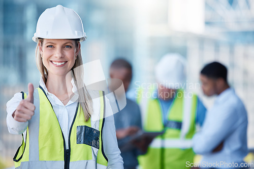 Image of Portrait, thumbs up and a woman construction worker outdoor on a building site with her team in the background. Management, thank you and support with a happy female architect outside for motivation