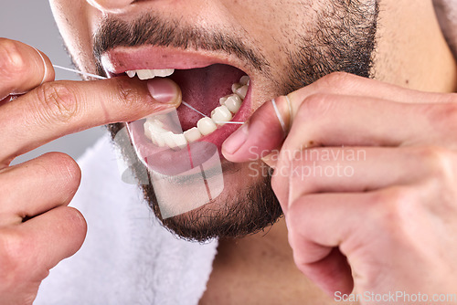 Image of Mouth, dental and man floss teeth in studio isolated on a background for healthy hygiene. Tooth, flossing product and closeup of male model cleaning for oral wellness, fresh breath and gums.