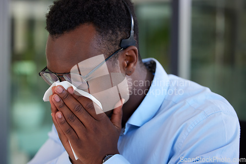 Image of Call center, business and black man with a tissue, sneeze and flu with allergies, telemarketing and health issue. Male person, consultant and agent with illness, sick and virus with medical symptoms