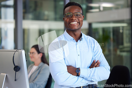 Image of Portrait, arms crossed up and a black man at work in a call center for support or crm assistance. Customer service, confident and professional with a happy male consultant working in telemarketing