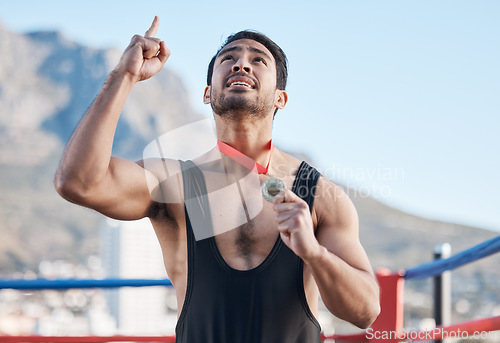 Image of Winning, boxing medal and a man with thanks to God, celebration and sports gratitude. Success, young and a boxer with pride and award from a sport competition and grateful to commitment of a prize