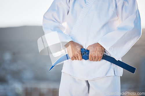 Image of Karate, exercise and fighting with a sports man in gi, training in the city on a blurred background. Fitness, discipline or strong with a male athlete during a self defense workout for health closeup