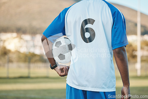 Image of Sports, soccer ball and man with player number on a field for exercise, fitness and training outdoor. Football club, pitch and game with back of athlete person for professional sport competition