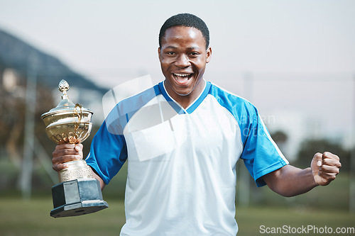 Image of Sports, soccer player and man celebrate trophy for competition or game outdoor. Portrait of black male athlete champion excited for football prize, award and win or achievement and success on a field