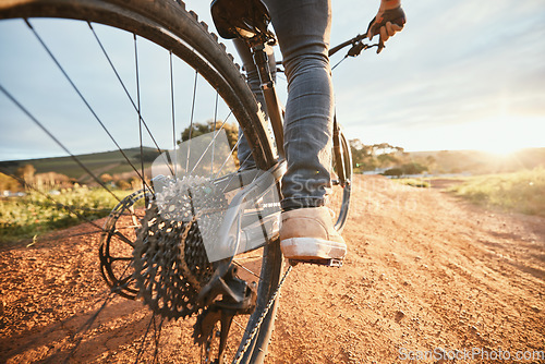 Image of Feet, cycling and a man on a bike and dirt road for fitness, morning cardio or adventure in nature. Sports, tire and a person on a bicycle for a race, competition or exercise in the countryside