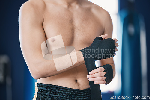 Image of Sports, boxing and man wrap hands in gym for training, workout and exercise for mma fight. Fitness, body builder and male athlete with bandage prepare for boxer competition, practice and performance