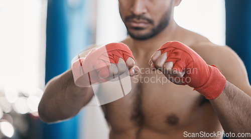 Image of Sports, boxing and hands of man punch in gym for training, workout and exercise for mma fight. Fitness, body builder and closeup of male athlete ready for boxer competition, practice and performance